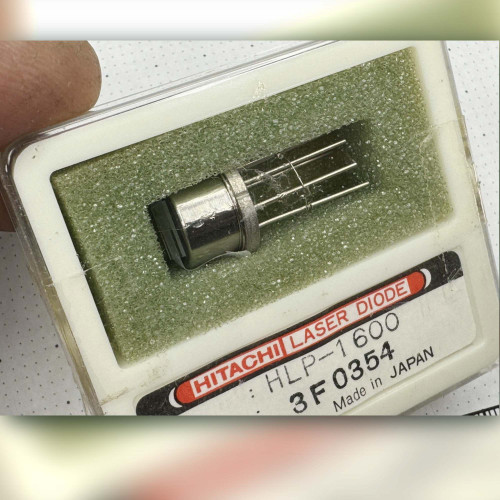 Close-up of HLP-1600 metal can laser diode seated in green foam, Hitachi factory label visible