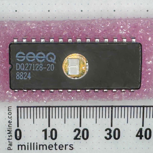 SEEQ DQ27128-20 ceramic EPROM top view on pink antistatic foam beside millimeter ruler