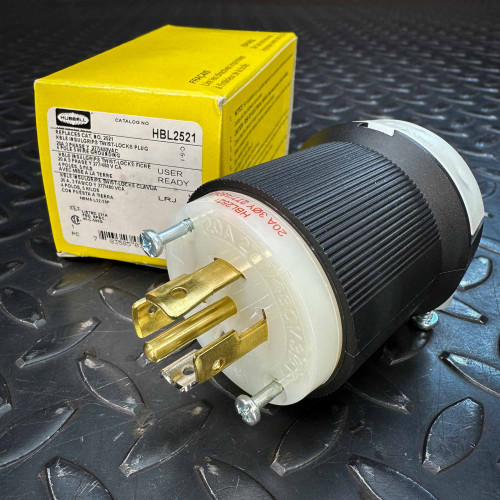 Hubbell HBL2521 Twist-Lock Plug 20A 277/480V 4P 5W Insulgrip from PartsMine.com shown in front of its yellow retail box, both placed on a textured black metal surface. Hubbell HBL2521 Twist-Lock Plug 20A 277/480V 4P 5W Insulgrip from PartsMine.com shown in front of its yellow retail box, both placed on a textured black metal surface.