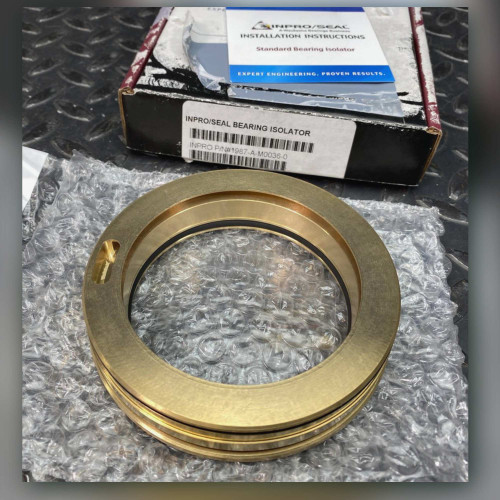 Inpro/Seal 1987-A-M0036-0 bronze bearing isolator on bubble wrap beside its labeled box and instruction sheet