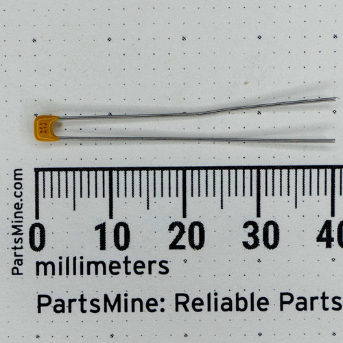 Radial ceramic capacitor 471-A1J shown against a millimeter scale.