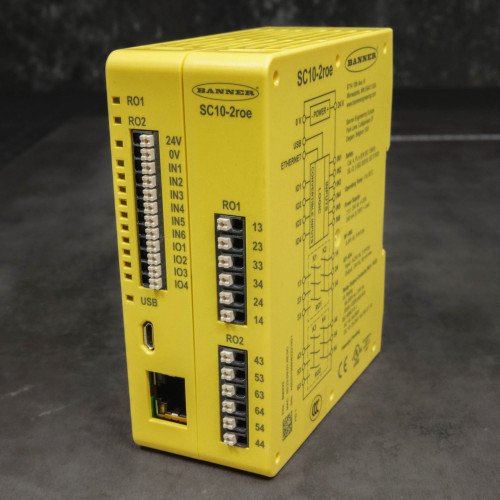 Three-quarter view of yellow Banner SC10-2roe, terminal face and printed side schematic visible