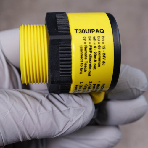 Banner T30UIPAQ label showing wiring diagram and teach instructions, clean yellow body, intact 30mm threads.