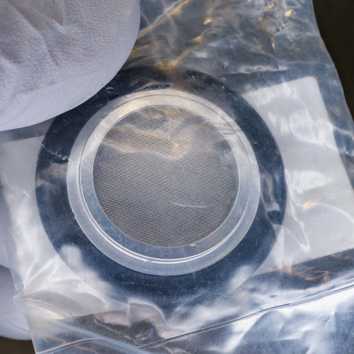 KF25 centering ring with screen inside plastic bag, showing clean FKM O-ring and intact mesh screen.