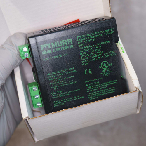 Black DIN-rail unit; label reads ART. NO.: 85161, 24VDC 1.3A output, 100-240VAC input, IP20, UL Listed, made in Czech Republic.