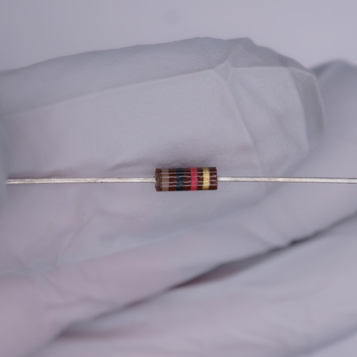 Axial carbon composition body with brown base coat; color bands read brown, black, red, yellow — leads straight and untrimmed.