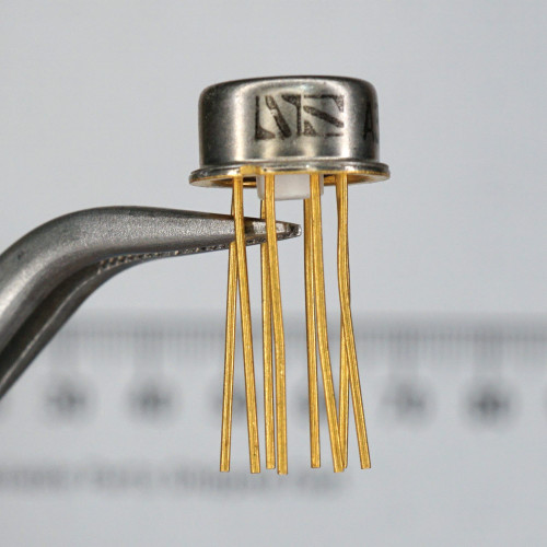 TO-99 metal can with silver finish; stamped markings partially visible on cap. Eight gold-plated leads, unclipped, no visible bends or damage. National Semiconductor logo in older NS monogram variant clearly visible.