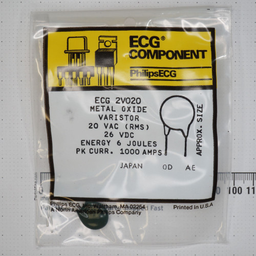 Dark green disc body with axial leads visible through bag. Label reads 20 VAC RMS, 26 VDC, 6 joules, 1000 amps peak, Japan origin.