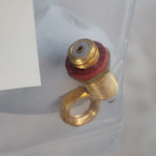 Gold-plated threaded connector with red insulating flange and eyelet lug base; gray dielectric insert visible at top. No markings legible.