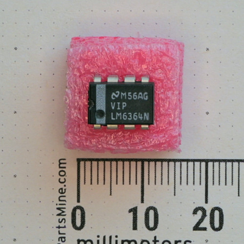 Top view of National Semiconductor LM6364N 8-pin DIP IC on pink foam next to a metric ruler.