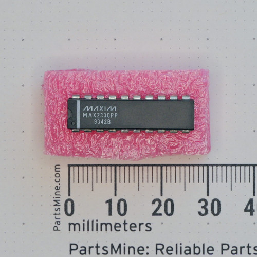 Maxim MAX233CPP integrated circuit in a 20-pin DIP package on pink foam next to a metric ruler.