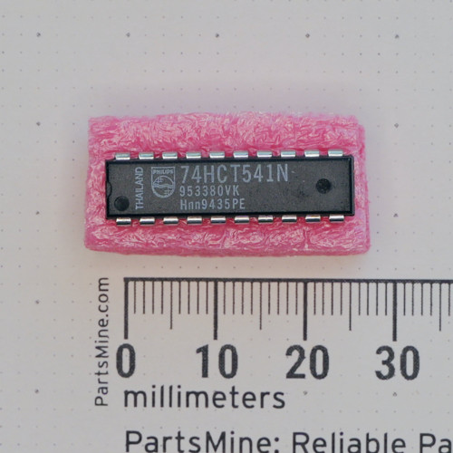 Top view of a Philips 74HCT541N DIP-20 integrated circuit on foam next to a metric ruler.