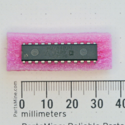 Analog Devices AD7840JN IC in a 24-pin DIP package on pink foam next to a millimeter ruler.
