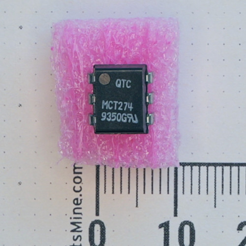 Top view of QTC MCT274 6-pin DIP IC on pink foam next to a scale.