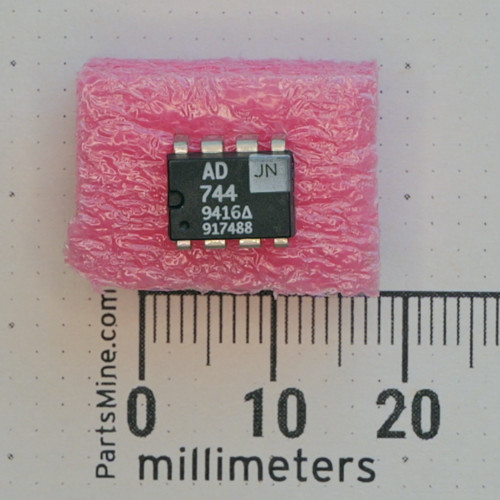 Analog Devices AD744JN 8-pin DIP IC on pink foam next to a metric ruler.