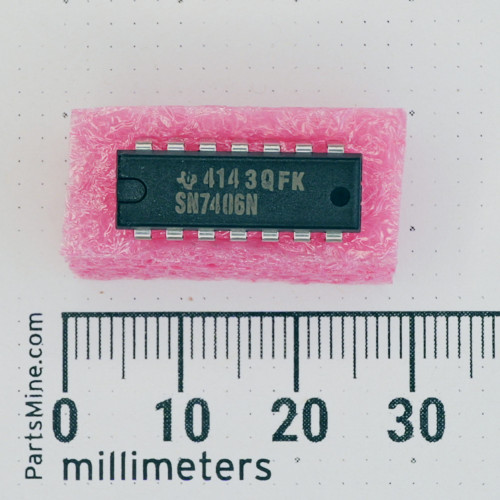Texas Instruments SN7406N DIP-14 IC on pink foam next to a millimeter scale.