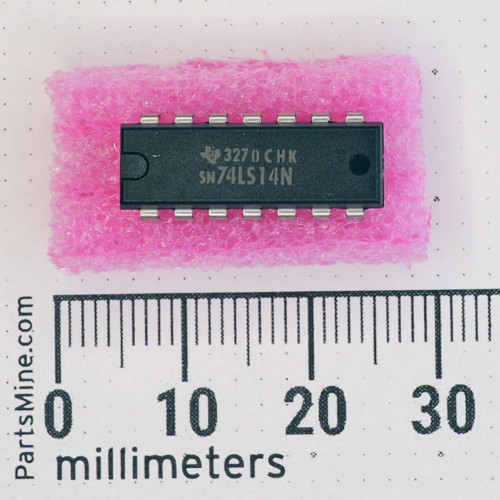 Top view of Texas Instruments SN74LS14N DIP-14 IC on pink foam next to a millimeter ruler.