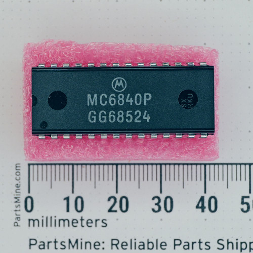 Top view of a Motorola MC6840P DIP-28 integrated circuit on pink foam.