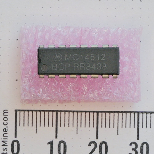 Motorola MC14512BCP 16-pin DIP integrated circuit on pink foam.