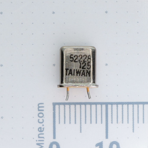 Side view of crystal marked 52228 125 TAIWAN over a metric scale.