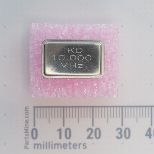 Top view of TKD 10.000 MHZ oscillator on foam with millimeter ruler.