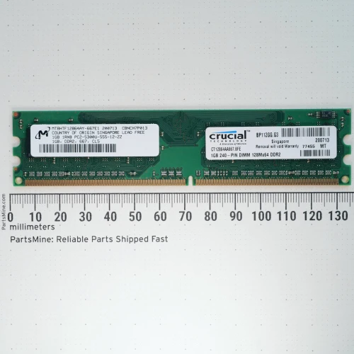 Crucial MT8HTF12864AY-667E1 1GB DDR2 RAM module with a millimeter ruler.