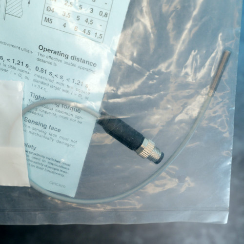 Threaded barrel and cable connector of Contrinex DW-AV-623-M4-276 proximity sensor in bag.
