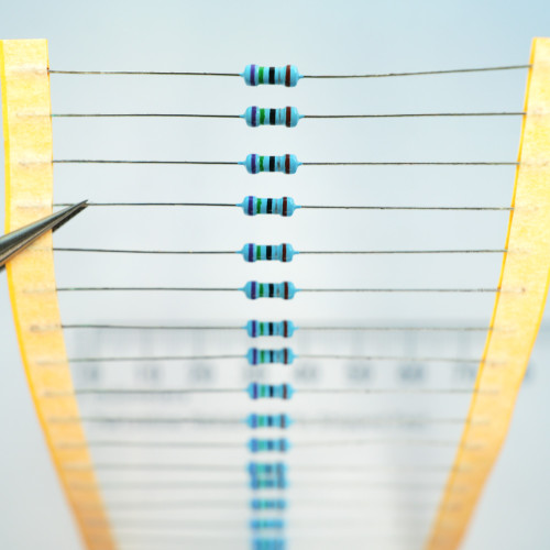Tape strip of through-hole axial lead resistors with blue bodies and color bands.
