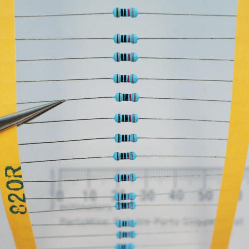 Tape-and-reel strip of 820 ohm axial lead resistors marked 820R on tape.