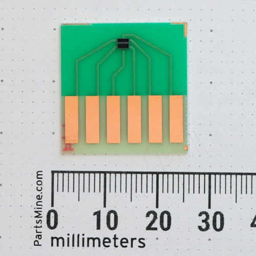 Top view of Nisshinbo NJL9101R sensor mounted to carrier board with metric scale.