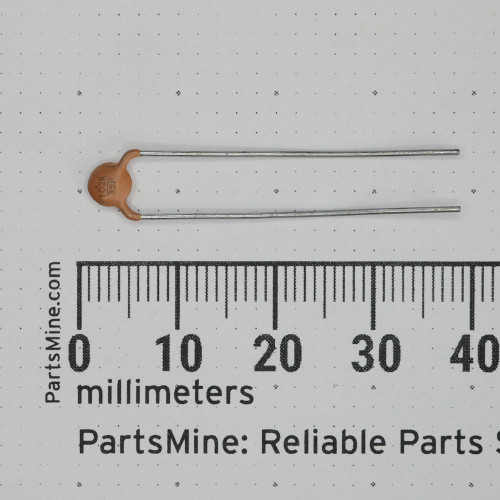 Motorola 21-82187B14 ceramic disc capacitor alongside a metric ruler.