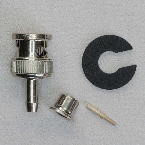 Disassembled components of Amphenol 31-4700 BNC connector with ferrule, pin, and gasket.