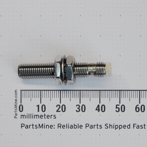 Profile view with millimeter ruler of Balluff BES 00P7 inductive proximity sensor.