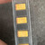 Three yellow C-case SMD tantalum capacitors marked 106C and N29ZH, polarity stripe visible on each body.