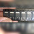 Hand holding black carrier tape strip of six DPAK diodes marked 8EWS08S