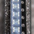 Carrier tape strip of resettable fuse chips marked -T on a dark speckled surface