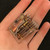 R10-E1W4-115V 4PDT relay held in hand, showing armature, gold contact sets and terminal comb