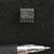 Spansion FL128PIF 16-pin SO flash chip on a dark textured surface beside a pen for scale