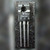 National Semiconductor 2N4921 transistor marked E C B, three leads, on a dark speckled surface