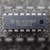 Motorola MC14094BCP 16-pin plastic DIP chip lying on gray surface, marking upright
