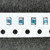 Four blue-body SMD resistors on carrier tape, each marked 1620 in black print, silver terminations visible, no damage observed.