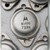 Underside of one TO-3 can held in a hand, two gold-coloured pins stamped E and B