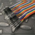 Close-up of male header pin connectors on PartsMine M/M200mmJW jumper ribbon.