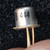 TO-18 metal can with silver finish; partial marking visible reads 8 444; three gold leads, no visible damage or corrosion.