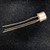 TO-18 metal can package, silver body with gold flange, three gold leads intact, no visible markings on can face from this angle.