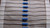 Multiple RG Allen 5K760 Ohm 1% blue resistors with color bands, packaged in rows on tape.