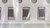Three taped chip capacitors with silver terminations, bag film creasing across the strip