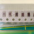 Five brown ceramic chip capacitors with silver-grey ends, part of a sixth at right edge