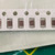 A row of brown ceramic chip capacitors with silver-grey end terminations, top view