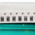Close view of two whole and two partial brown ceramic chip capacitors with silver-grey end terminations